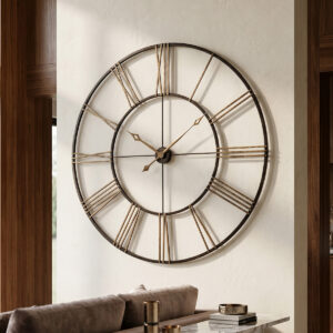 Aged black wrought-iron open-frame wall clock with antique gold numerals