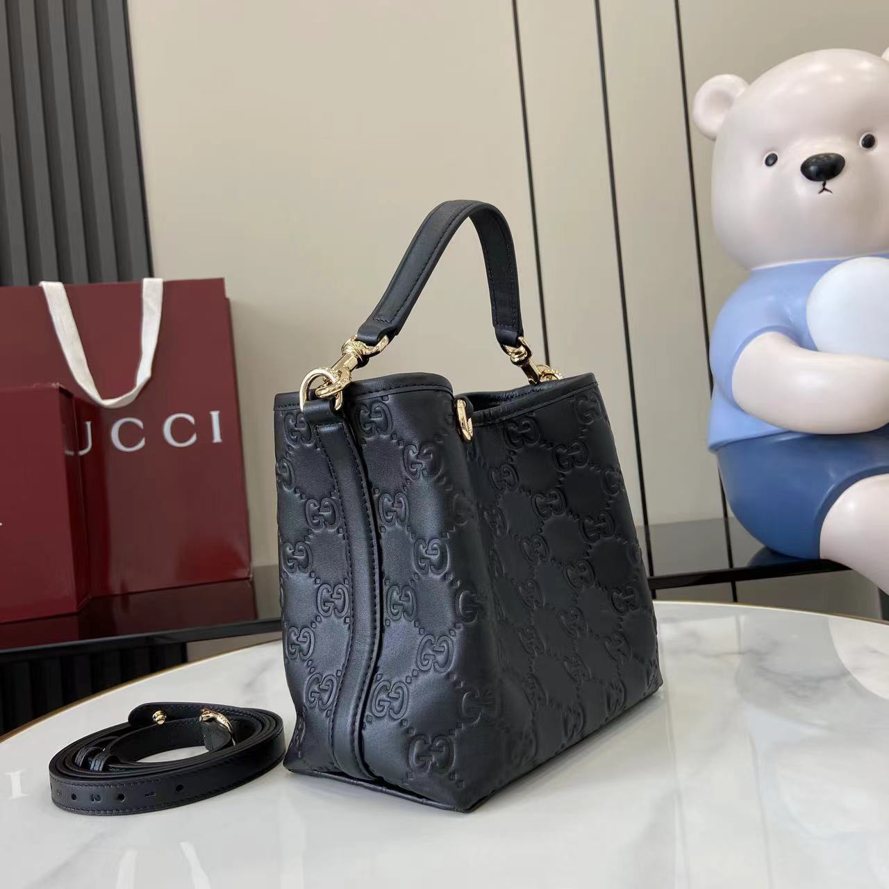 Gucci GG Emblem Small Bucket Bag GG Print Embossed Leather - Black
