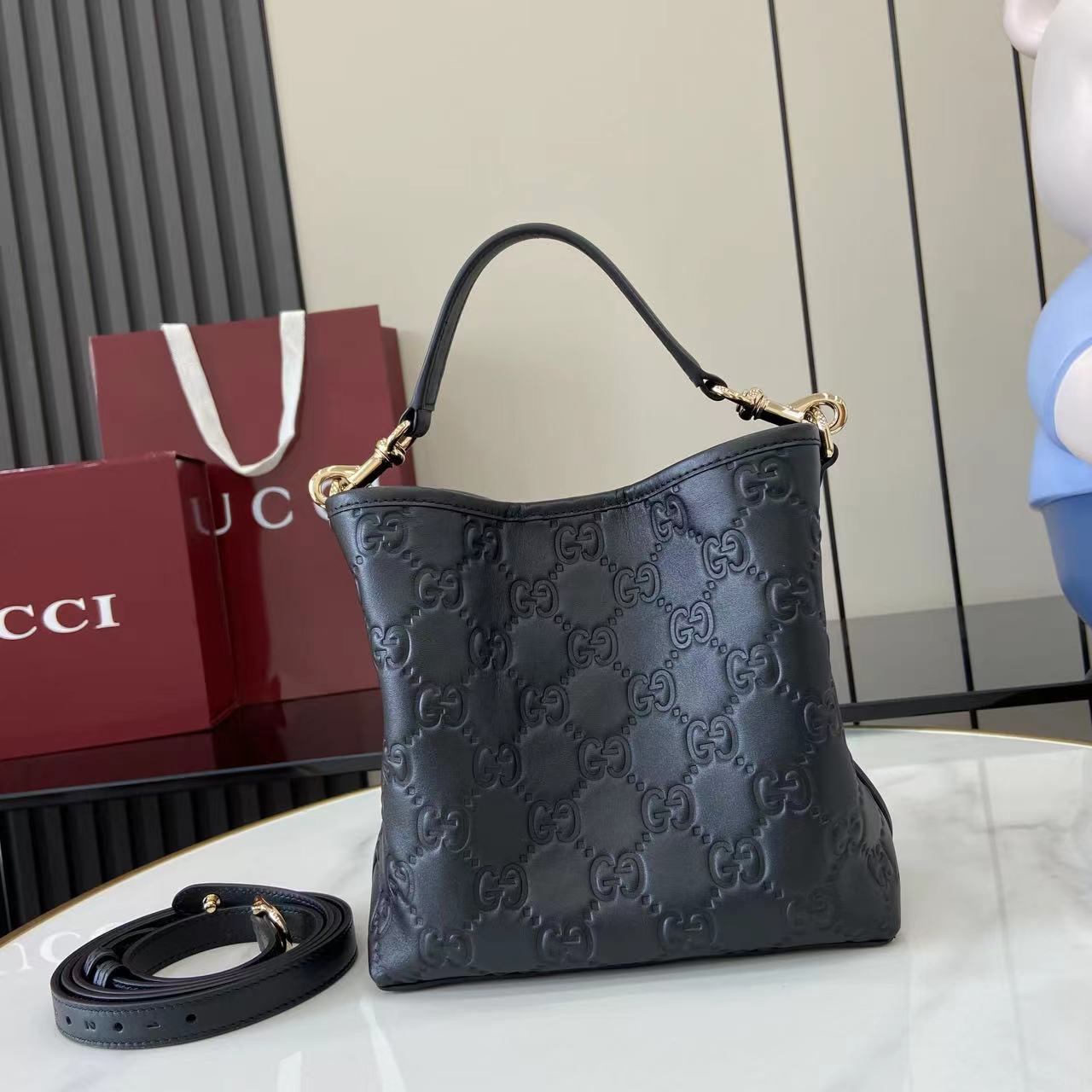 Gucci GG Emblem Small Bucket Bag GG Print Embossed Leather - Black