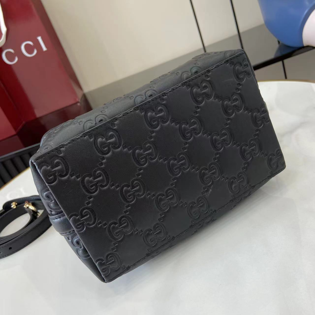Gucci GG Emblem Small Bucket Bag GG Print Embossed Leather - Black