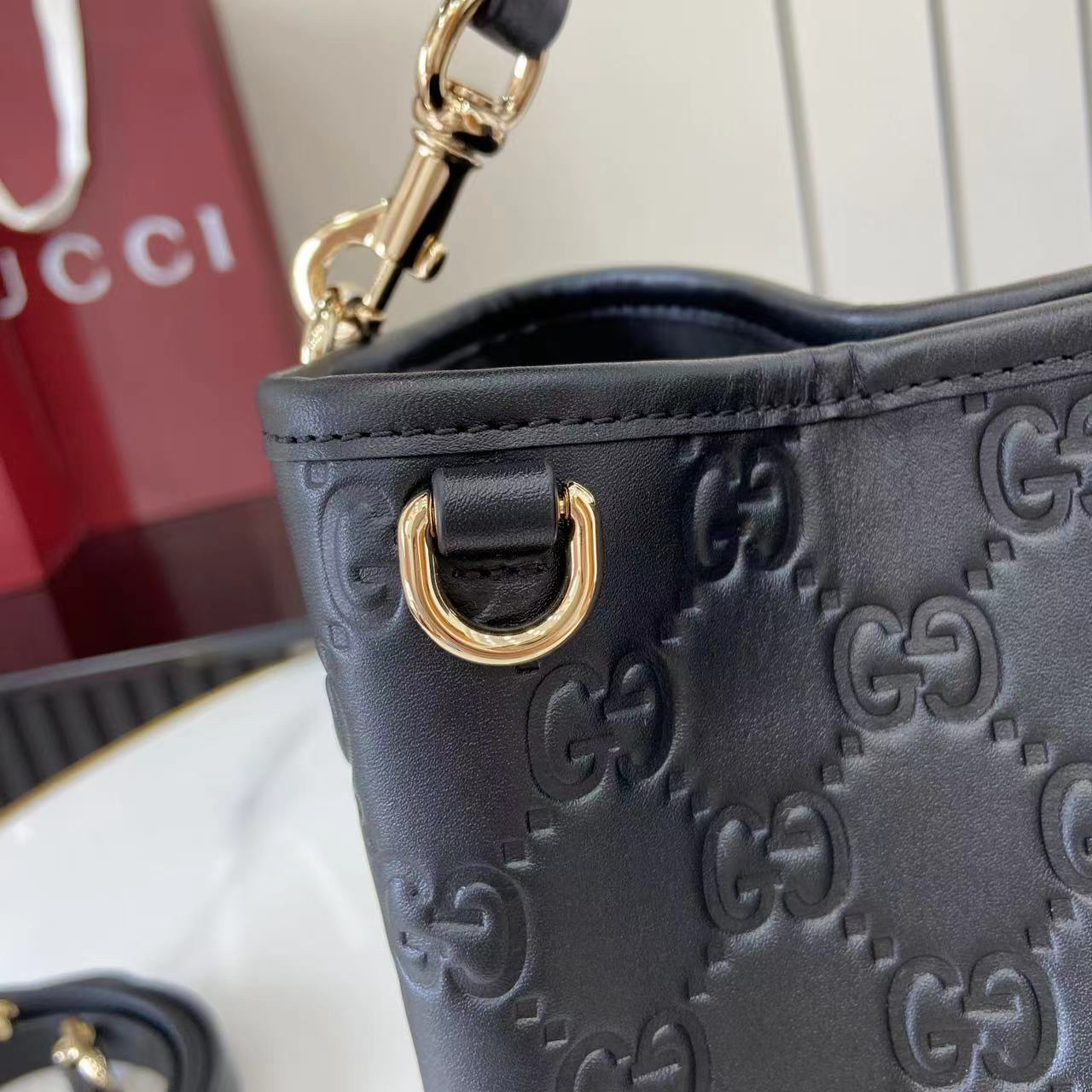 Gucci GG Emblem Small Bucket Bag GG Print Embossed Leather - Black