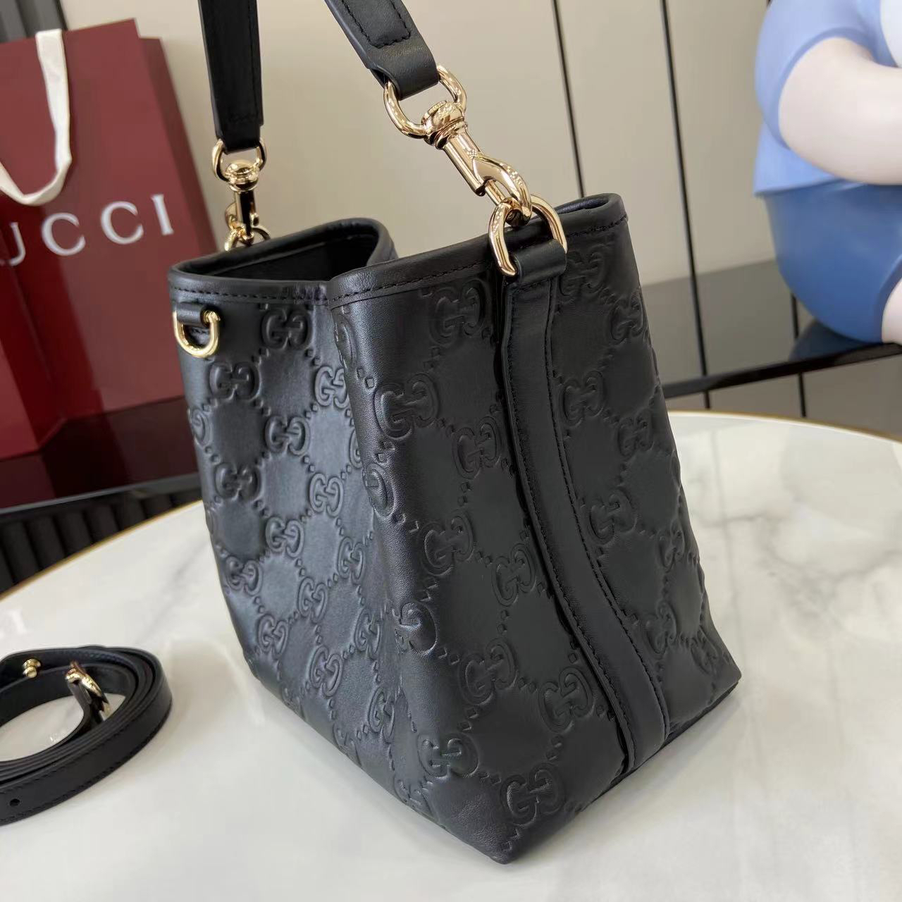 Gucci GG Emblem Small Bucket Bag GG Print Embossed Leather - Black