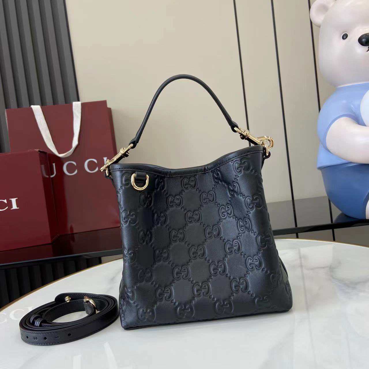 Gucci GG Emblem Small Bucket Bag GG Print Embossed Leather - Black
