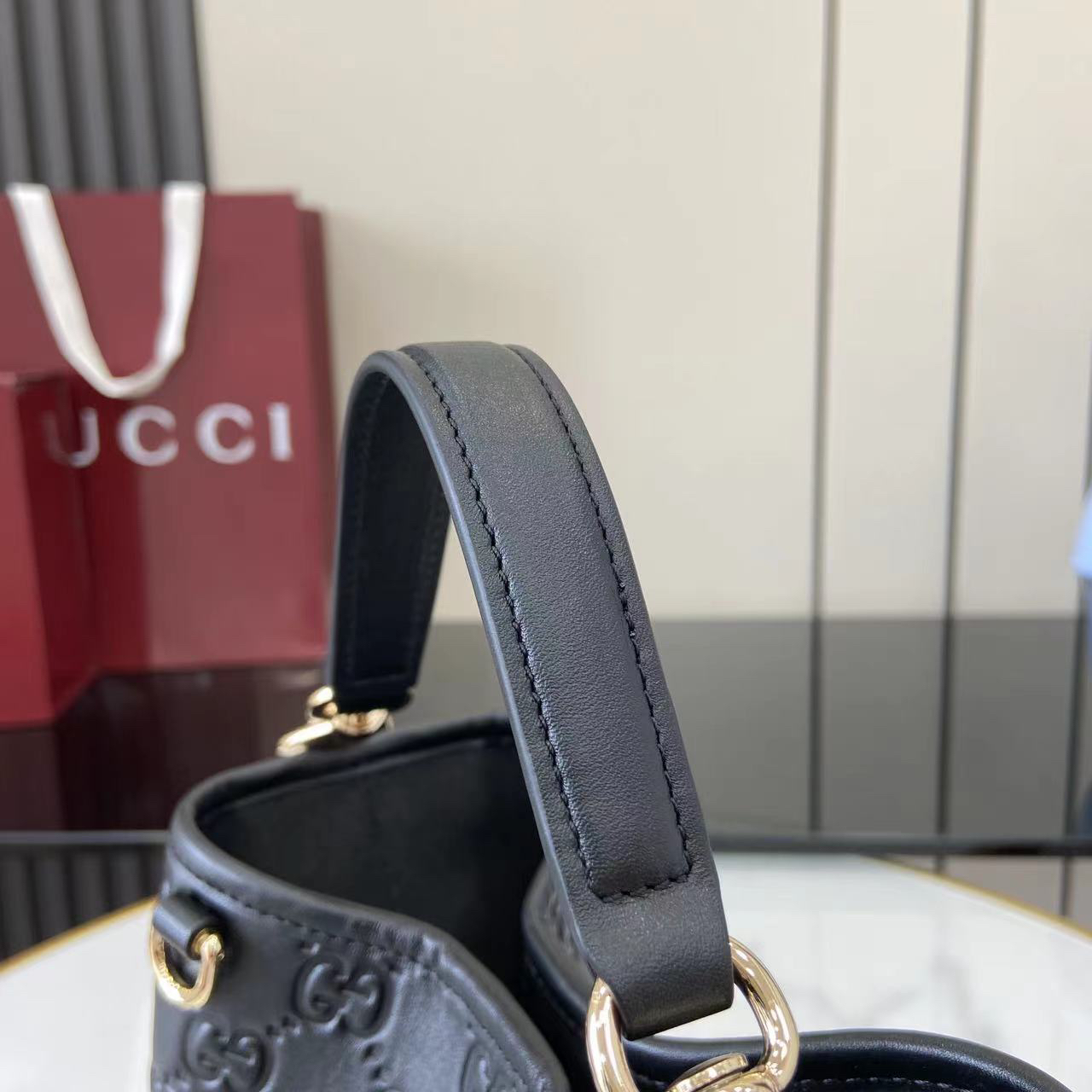 Gucci GG Emblem Small Bucket Bag GG Print Embossed Leather - Black
